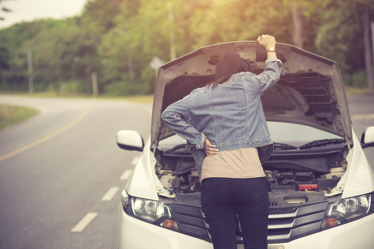 Woman opening hood in a roadside assistance call near Plantation FL